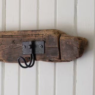 Close-up rustic wooden hook rail industrial metal hooks