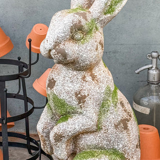 Distressed concrete rabbit statue with moss garden detail
