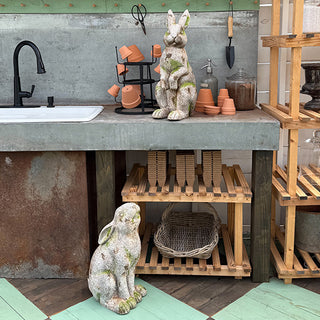 Faux concrete rabbit statues styled in potting shed decor
