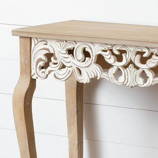Detail shot of hand-carved ornate scroll work on French Provincial console table featuring intricate white-painted carved detail against natural wood