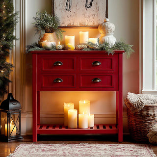 Rustic red wooden console table decorated with candles, greenery, and pumpkins for a cozy holiday home decor setting.