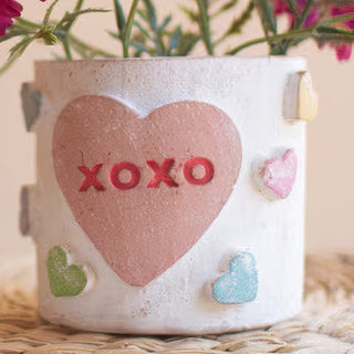 Clay XOXO conversation heart container detail shot showing handcrafted texture pink heart with XOXO lettering mint green blue pink dimensional hearts farmhouse Valentine decor
