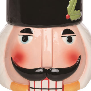 Close-up of nutcracker cookie jar facial features showing hand-painted eyes rosy cheeks bold black mustache and detailed craftsmanship on glossy dolomite surface