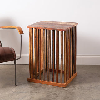 Mango wood slatted side table on concrete floor