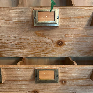 Wooden drawer with metal handles on a wooden surface; samplers counter