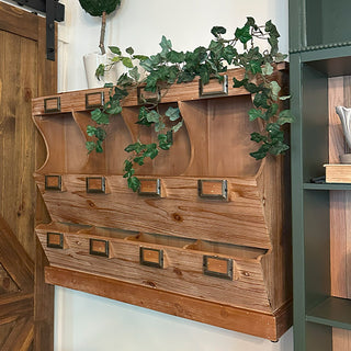 Wooden wall-mounted shelf with decorative elements and greenery; samplers counter