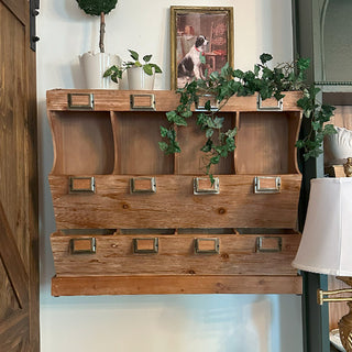 Wooden samplers counter with decorative elements including plants and a framed picture in a room setting.