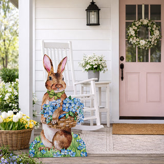  Hand-painted wooden bunny yard stake displayed on white farmhouse front porch beside rocking chair with pink door and spring flowers in background