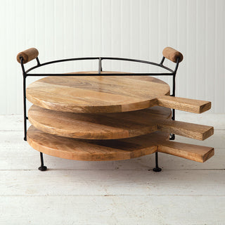 Stacked round wood cutting boards on metal stand