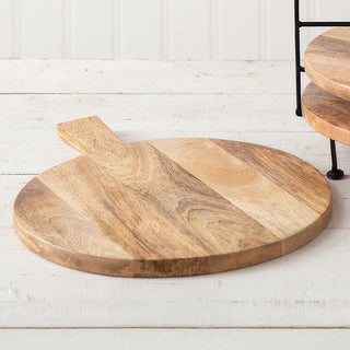 Single round wooden cutting board on white surface