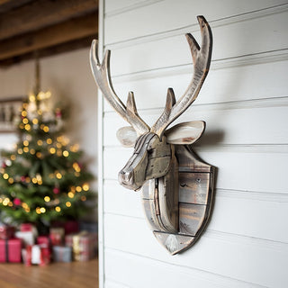 Rustic wooden deer head wall decor by Christmas tree