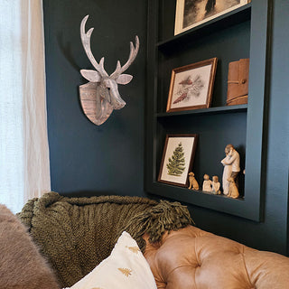 Deer head wall art in rustic living room nook