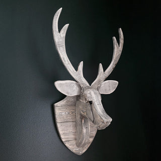 Rustic wood deer wall decor on dark wall
