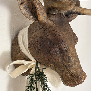 Detail view of distressed resin deer head mount showing hand-painted antique brown finish with natural wood grain texture and realistic sculpting