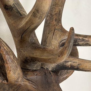 Close-up of realistic deer antler craftsmanship showing natural curves ridges and authentic distressed brown stonepowder resin finish