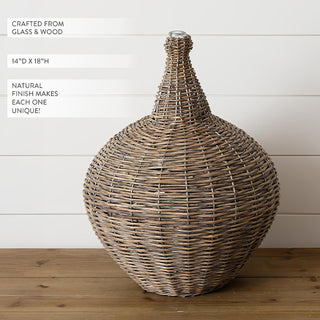  Large 18 inch tall natural wicker demijohn bottle with woven texture detail against white shiplap background