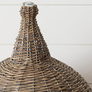 Close up detail of wicker demijohn neck showing intricate hand woven basket weave pattern and glass insert top