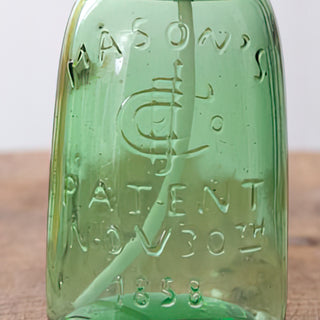 Embossed mason jar soap dispenser close-up green glass