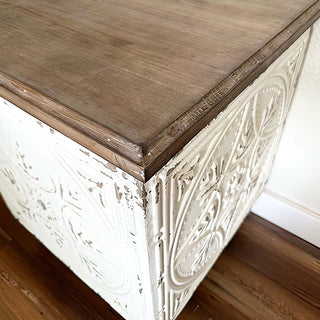 Architectural salvage table showcasing decorative texture and vintage craftsmanship