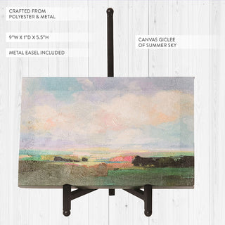 Canvas giclée summer sky landscape art with polyester material close-up showing texture and metal easel stand on white shiplap background