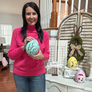 Woman holding decorative Easter egg home decor
