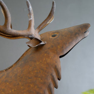 Close-up of elk head and antlers on distressed metal sculpture