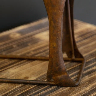 Detailed view of elk legs and textured metal finish on rustic decorative sculpture