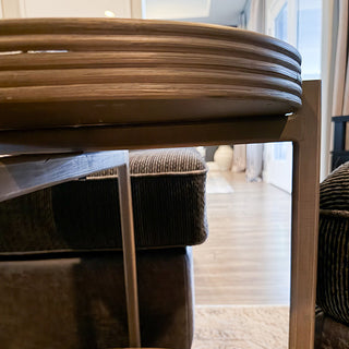 Side angle showing 4 inch bottom clearance underneath two-tier end table for robot vacuum access