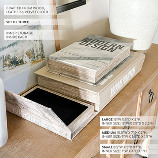 Decorative entryway console table styled with vases, artwork, and stacked faux book storage boxes used as home décor accents