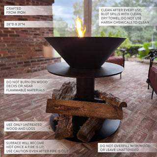 Close-up of black iron fire bowl with burning firewood, displayed on a brick patio with labeled care and safety instructions for outdoor use.