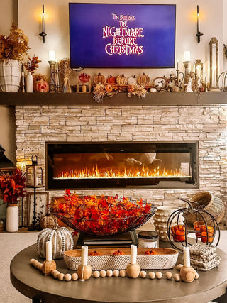 lanterns on a fireplace mantel with Halloween decor and fall decor