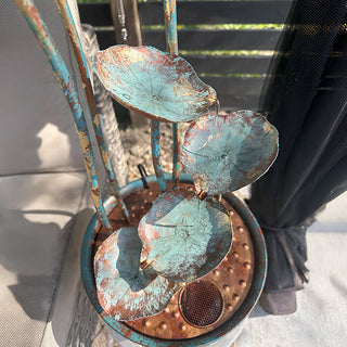 Patina metal lotus leaves water feature detail