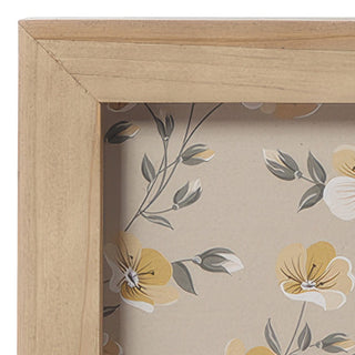Detail of natural wood frame corner showing craftsmanship and floral pattern matte border