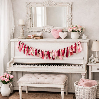 Valentine's Day handcrafted fabric ribbon tassel garland with pink red cream colors on white piano farmhouse decor