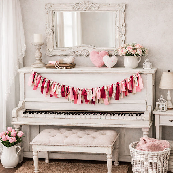 Valentine's Day handcrafted fabric ribbon tassel garland with pink red cream colors on white piano farmhouse decor