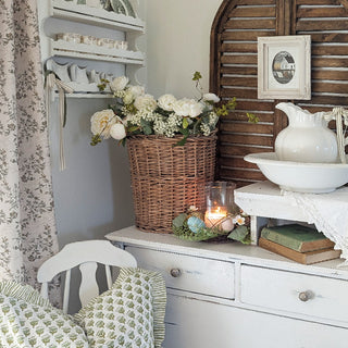 Farmhouse shelf decor with spring candle centerpiece