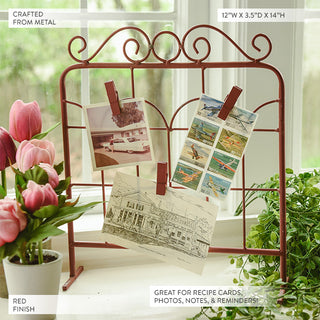  Decorative red metal photo card holder with scrollwork detail displaying vintage photographs and stamps, 12 inch wide by 14 inch tall