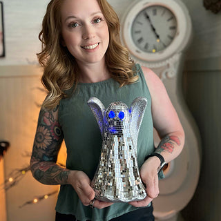 woman holding disco ghost halloween decor