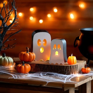 Pair of illuminated ghost candle lanterns with pumpkins and fairy lights