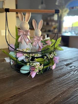 Black metal wire storage basket with natural wood handles and white bunny figurines with pink bows and easter decor spring decor farmhouse nesting organization in graduated sizes