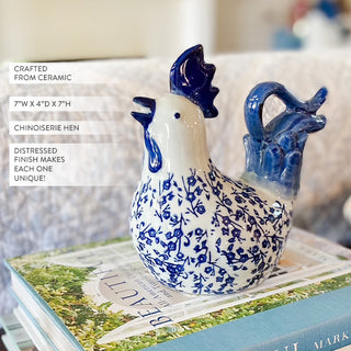 Ceramic chicken figurine with blue patterns on a book