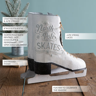 Close-up of distressed white metal ice skate decor with embossed North Pole Skates lettering, jute string laces, and rustic winter farmhouse design details