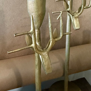 Close-up detail of forged-iron reindeer antler design on antique gold taper candle holders