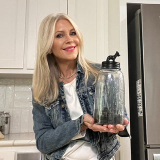 Woman holding decorative glass dog treat jar