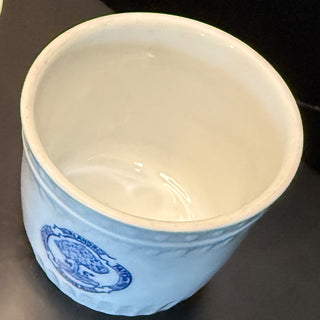 Close-up of antique white stoneware pot featuring blue “Confitures Mirland & Cie Frameries” logo, collectible European pottery detail