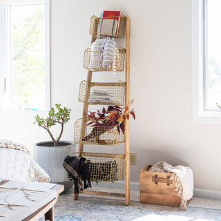 Farmhouse bedroom corner featuring wooden ladder with wire baskets