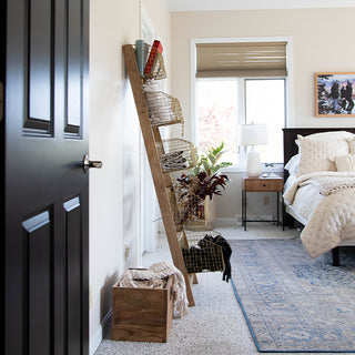 Modern farmhouse bedroom decorated with rustic ladder shelf