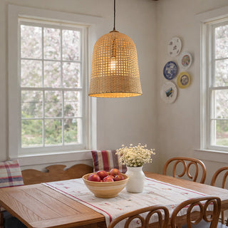 Handwoven natural grass bell pendant light over dining table with farmhouse decor