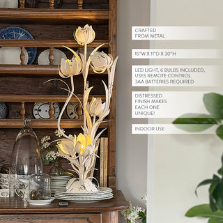 Vintage-style metal floral table lamp with hand-forged tulip petals and remote control on farmhouse console