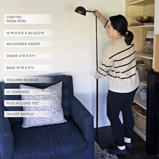 Adjustable black floor lamp shown in living room